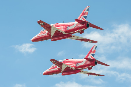 Farnborough, UK - July 17, 2016: Low-level flypast by the Red Arrows aerobatic display team at an...