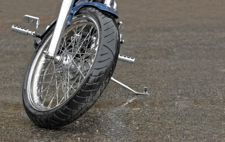 large motorcycle leaning on its stand in the rain