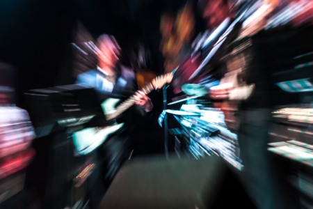 blurred motion of rock musicians on stage