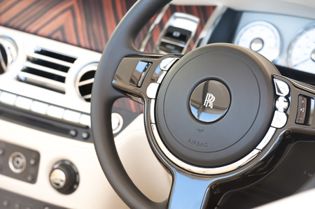 Laverstoke, Hampshire, UK - August 25, 2016: Luxurious steering wheel and dashboard closeup from a Rolls Royce Ghost automobile at the CarFest motoring event in Laverstoke, UKのeditorial素材