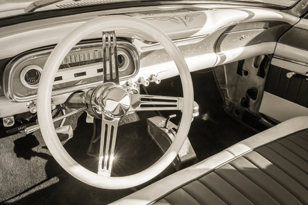 sepia toned vintage car interior and steering wheelの写真素材