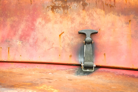 latch and peeling paintwork on a rusting metal panel background