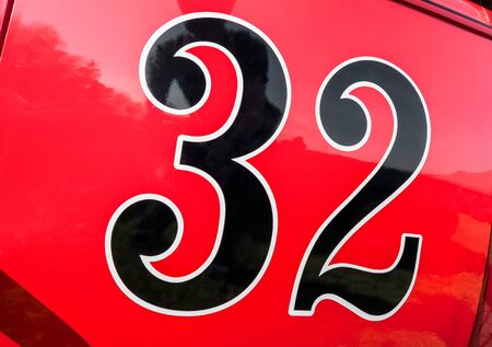 number 32 on the door panel of a red race car
