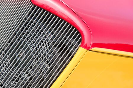 vehicle panel abstract with red and yellow panels next to the engine cooling fanの写真素材