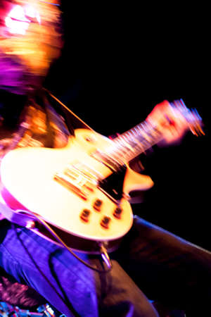 motion blur abstract of a rock guitarist with a golden guitar