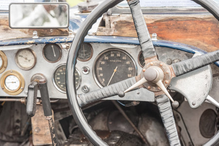 rusty and dusty vintage vehicle steering wheel and dashboard
