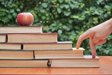 Old books on the table with apple の写真素材