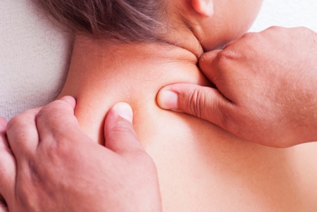 Close-up of a young woman receiving back massage at spaの写真素材
