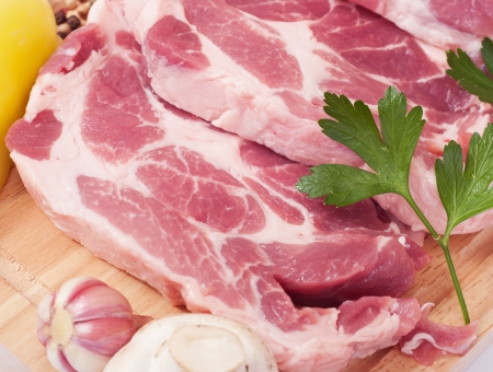 Cooking meat  Pork with vegetables on wooden board の写真素材