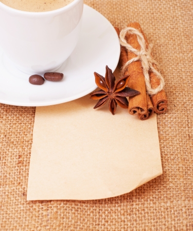 Frame of the old paper on burlap . With (cinnamon , beans, star anise , cup of coffee )の写真素材