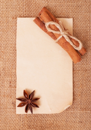 Frame of the old paper on burlap . With ( cinnamon and star anise )の写真素材