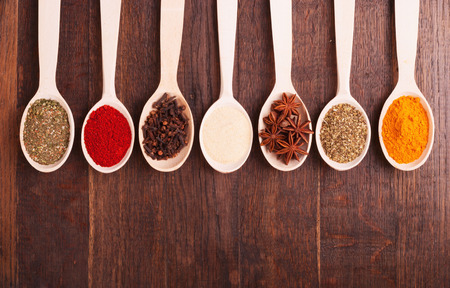 Various kind of spices in wooden bowls