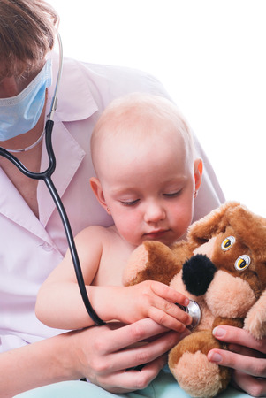 baby plays in doctor toy bear and stethoscopeの写真素材