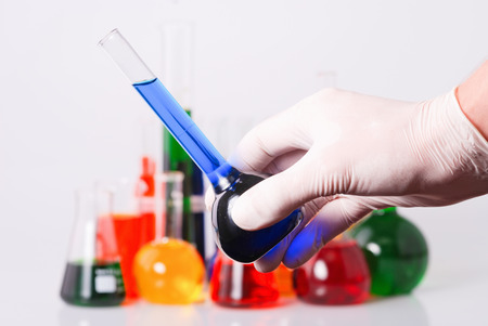 Glass tube with fluid in scientist hand during  laboratoryl testの写真素材