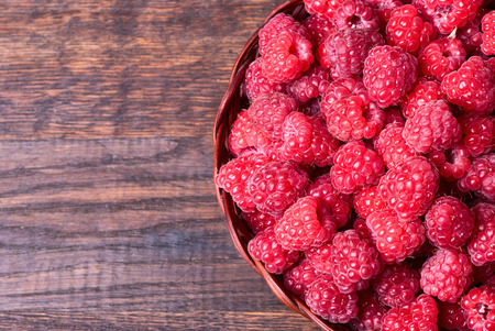 fresh raspberry in a basket on wooden table