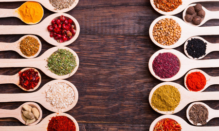 collection of various spices in wooden spoonsの写真素材