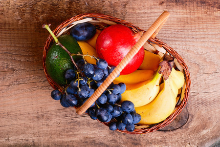 Many fresh colorful fruits in basketの写真素材