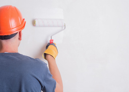 Painter On Stepladder Painting Wall With Brushの写真素材