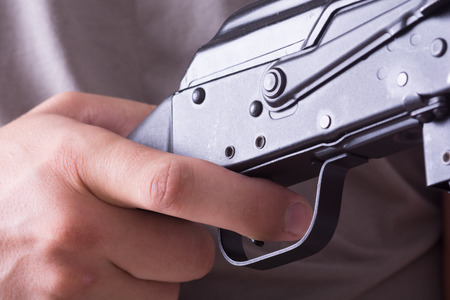 Finger on the trigger of a shotgun .