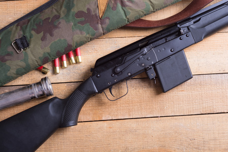 ammunition , flashlight , & rifle ( gun ) on wooden backgroundの写真素材