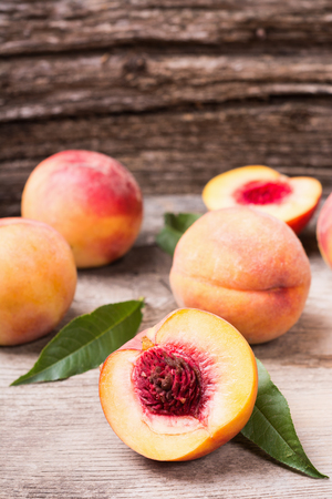 Group of fresh peaches on wood backgroundの写真素材