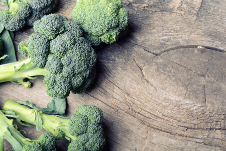 Bunch of fresh green broccoli on wooden backgroundの写真素材