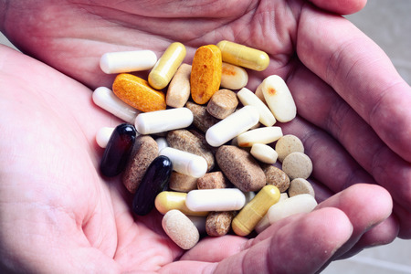 Man hand holding pills & tabletの写真素材