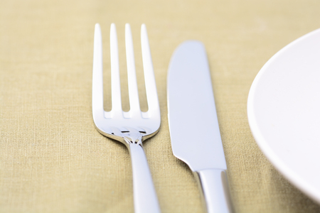 White empty plates with fork and knifeの写真素材