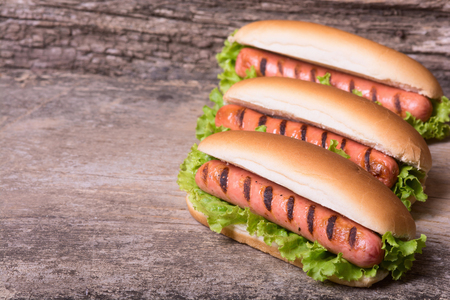 Barbecue Grilled Hot Dog with Yellow Mustard on wooden boardの写真素材