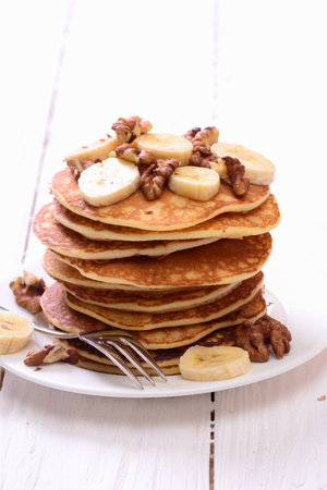 Pancakes with banana & walnut on wood background .の写真素材