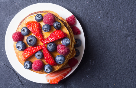 Pancakes with berries : blueberries , raspberry and strawberry .の写真素材