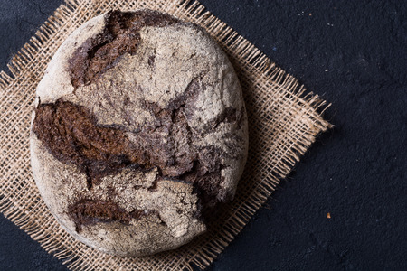 Rye bread on wooden board .  Top view