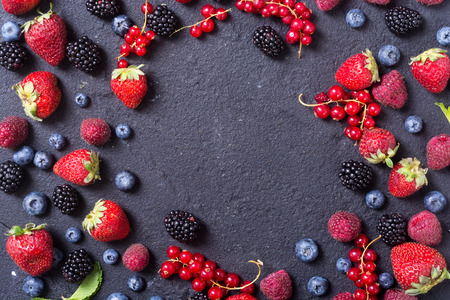 Berries background (raspberry , blueberry , strawberry , red currant , blackberry) Top view with space for textの写真素材