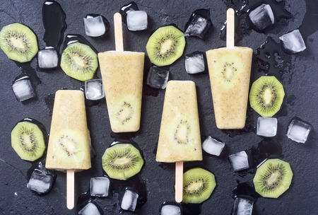 Homemade kiwi popsicle withe iceの写真素材