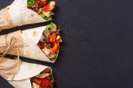 Mexican burrito with chicken , pepper and beans . Top viewの写真素材