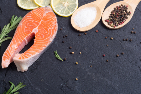 Ingredient for preparation salmon fish steak with lemon , pepper and saltの写真素材