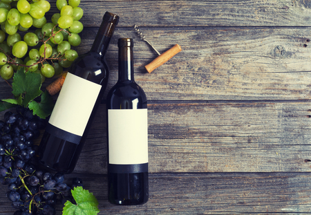 Red and white wine with grapes . On wooden backgroundの写真素材