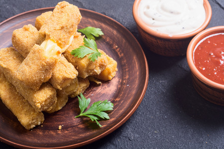 Fried cheese finger with sauces and parsleyの写真素材