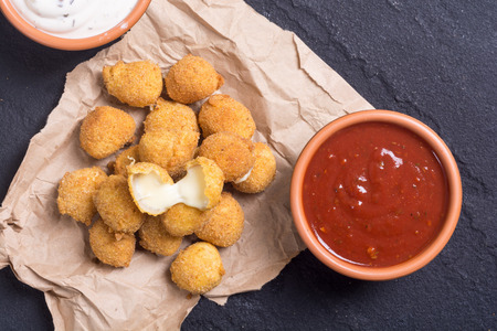 Fried breaded cheese balls with saucesの写真素材