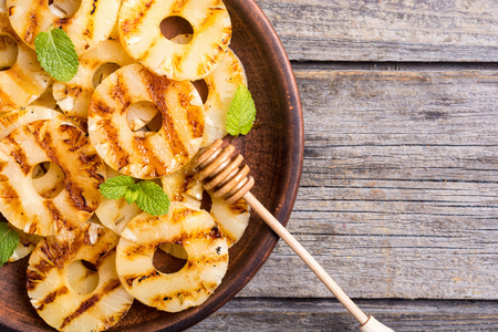 Grilled pineapple with mint and honeyの写真素材