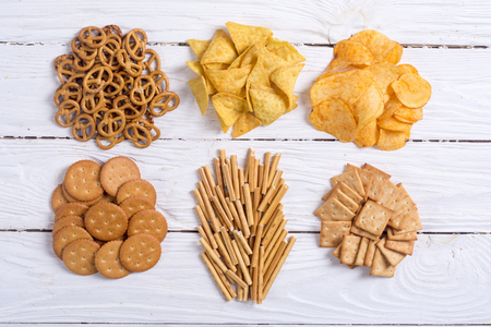 Mix of snacks : pretzels , crackers , chips , nuts and nachosの写真素材