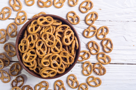 Pretzels in bowl on wooden background . Photo of snackの写真素材