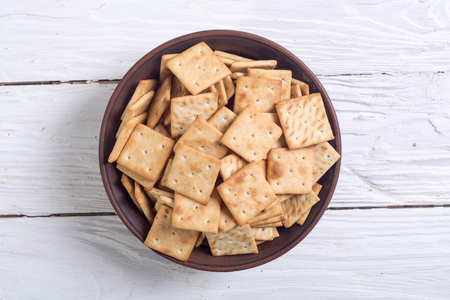 Homemade crackers in bowl on wooden backgroundの写真素材