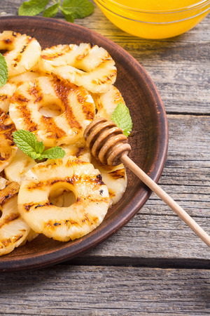 Grilled pineapple with mint and honeyの写真素材