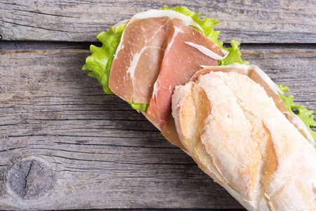 Sandwich with hamon and salad on wooden boardの写真素材