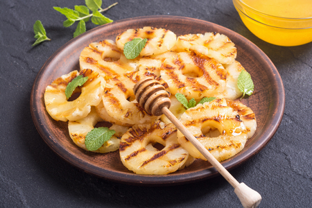 Grilled pineapple with mint and honeyの写真素材