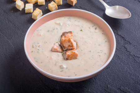 Cream soup with salmon and croutons .の写真素材