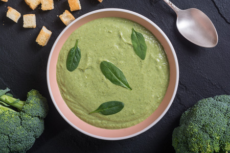 Cream soup with broccoli and baby spinach . Bowl with croutonsの写真素材