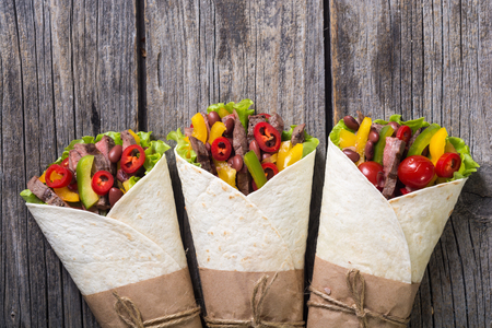 Burrito with beef , salad , tomato, peppers and haricotの写真素材