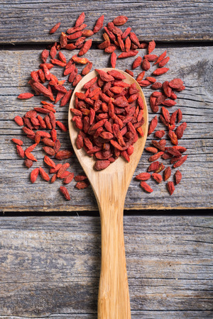 Goji berries in wooden spoon . Superfood backgroundの写真素材